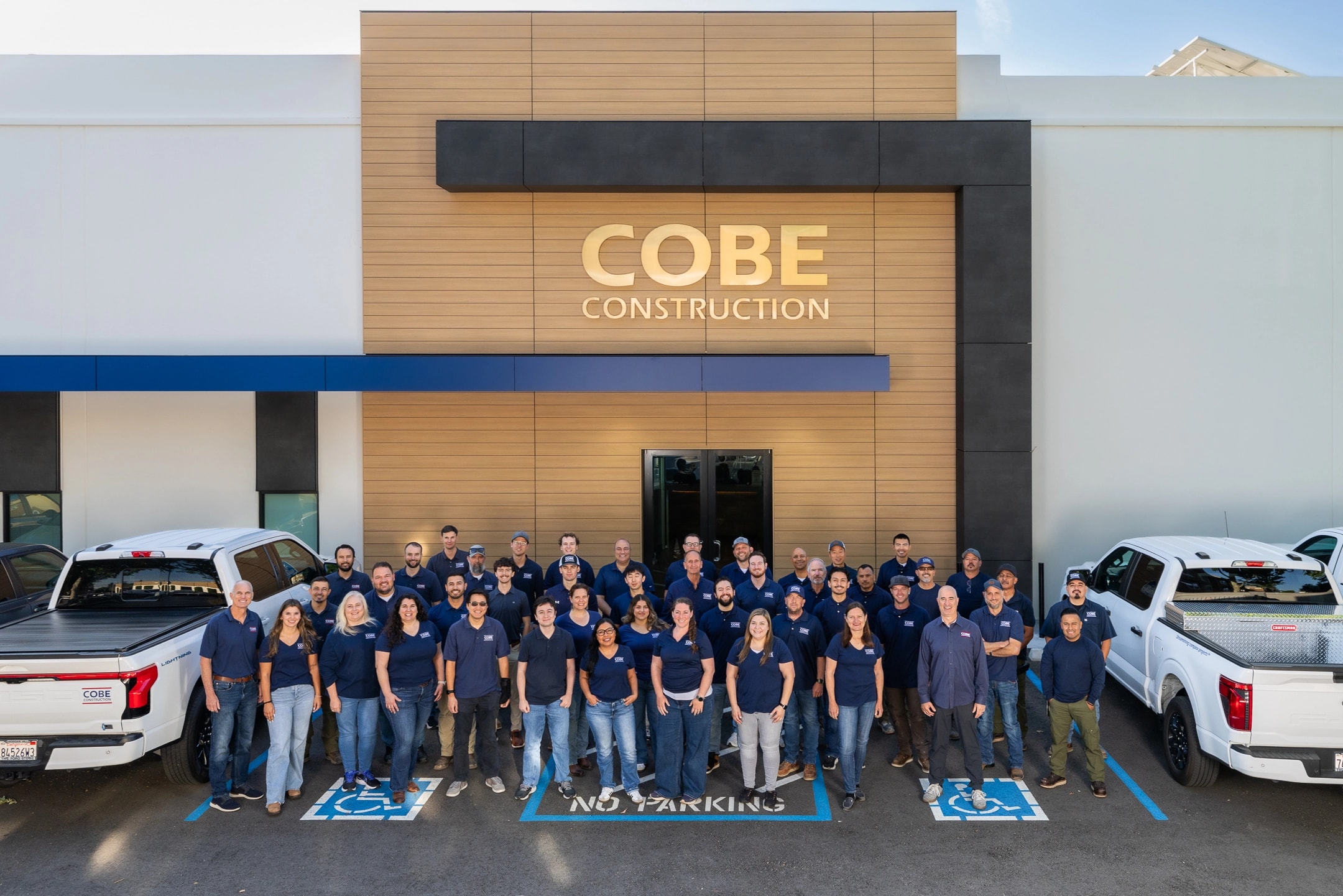 The full COBE Construction team in front of headquarters